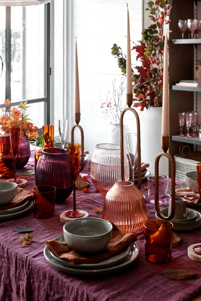 A mulberry dining setting with flowers and vases